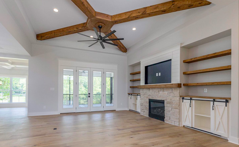 Open living room with exposed beams and fireplace