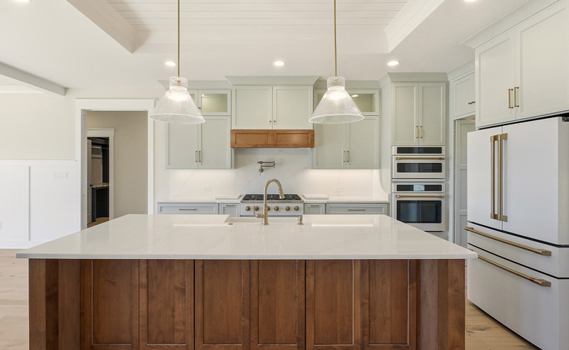 Custom kitchen with sea salt cabinets and quartz countertops